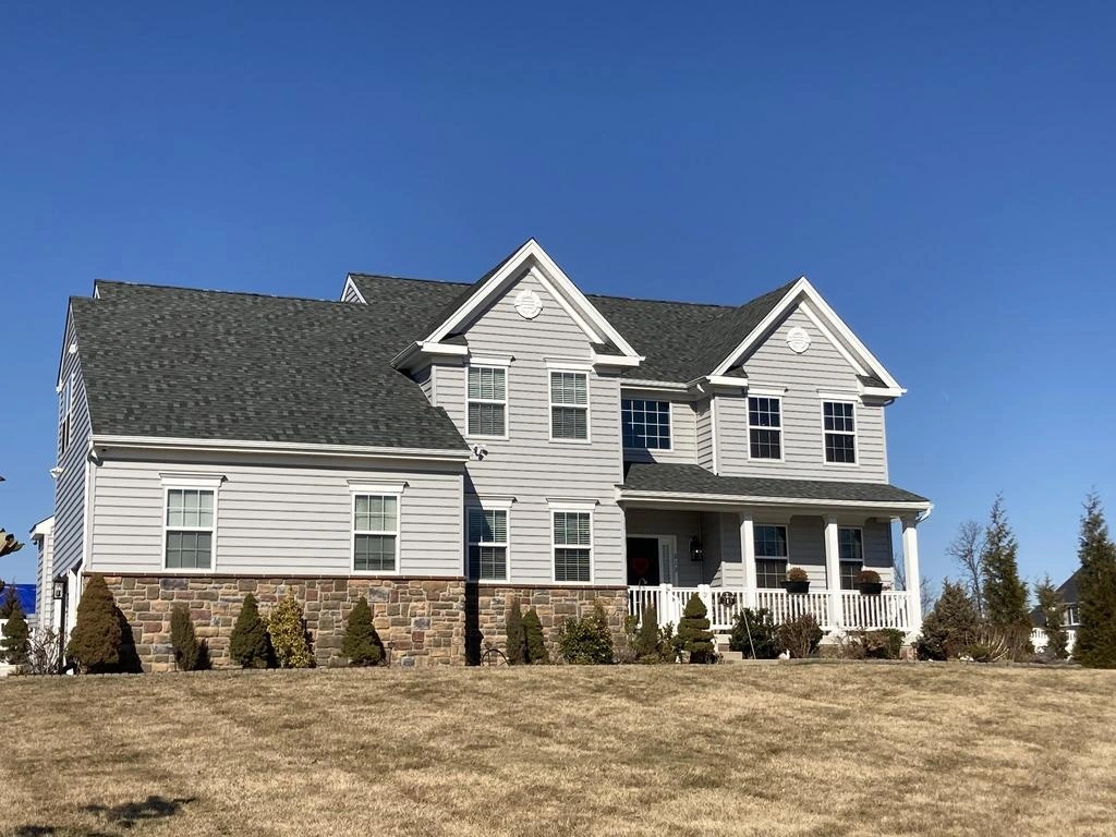 A home in New Jersey with a new roof installed by Sure Roofing and Exteriors