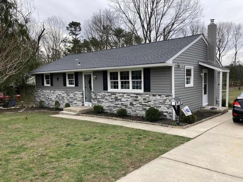 A New Jersey home with new gray siding installed by Sure Roofing & Exteriors