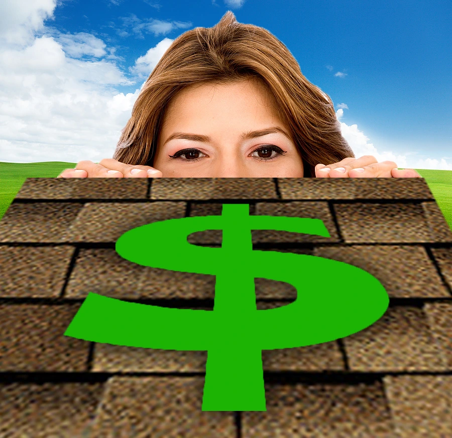 A woman peeking over a model of a shingle roof with a green dollar sign on the roof